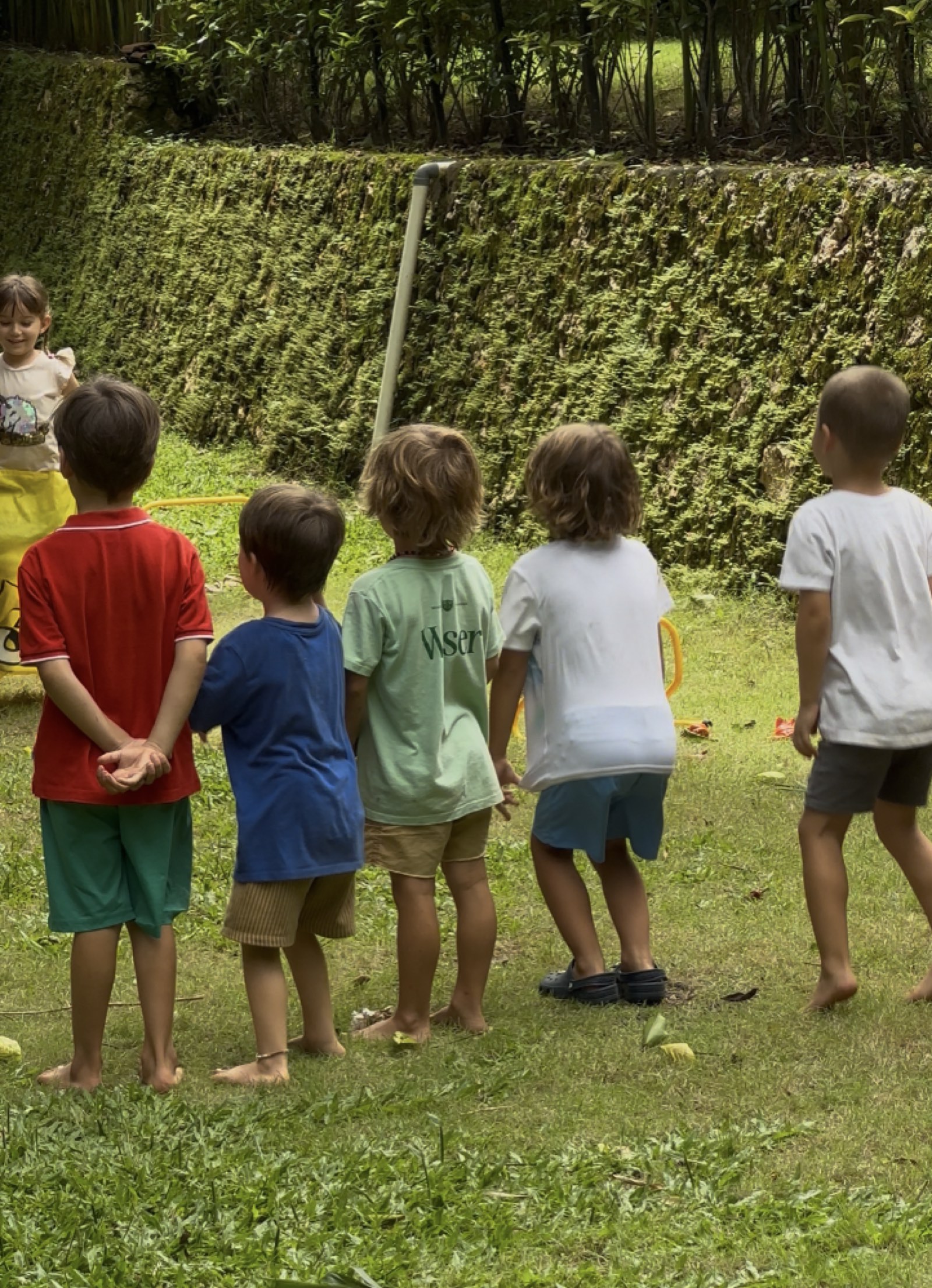 Students taking part in an outdoor group activity in a garden setting